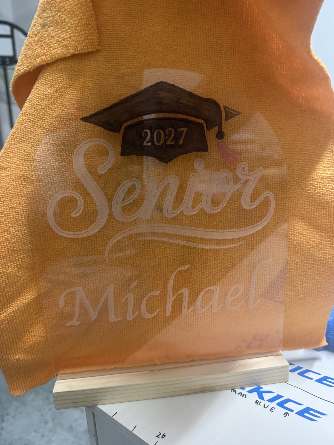 Personalized clear acrylic Senior 2027 Michael keepsake on a wooden stand
