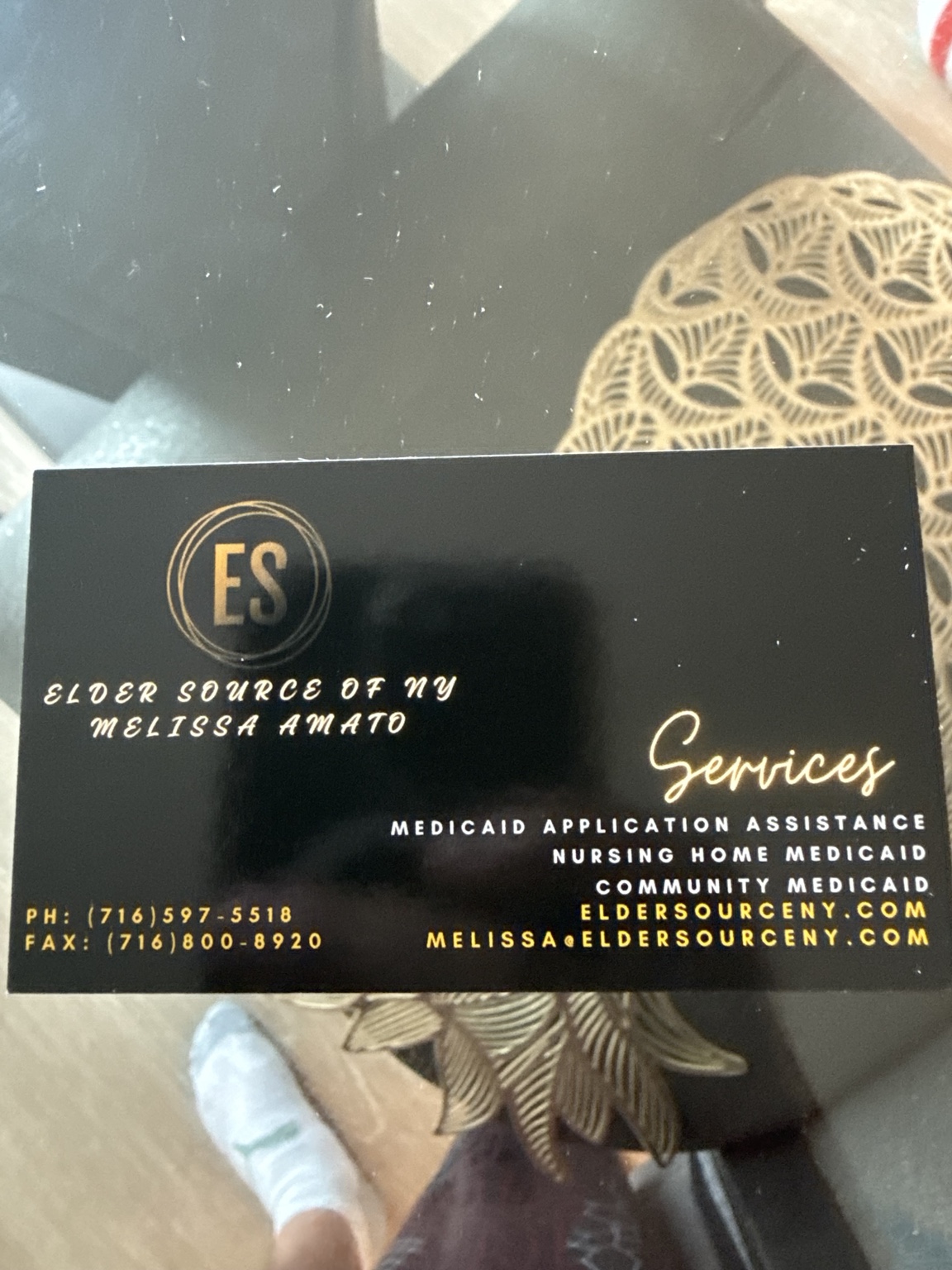 Black and gold Elder Source of NY business card