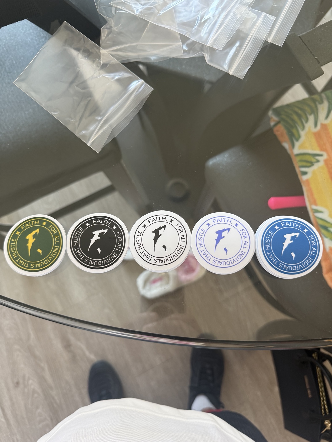 Five circular Faith business logo stickers in different color combinations
