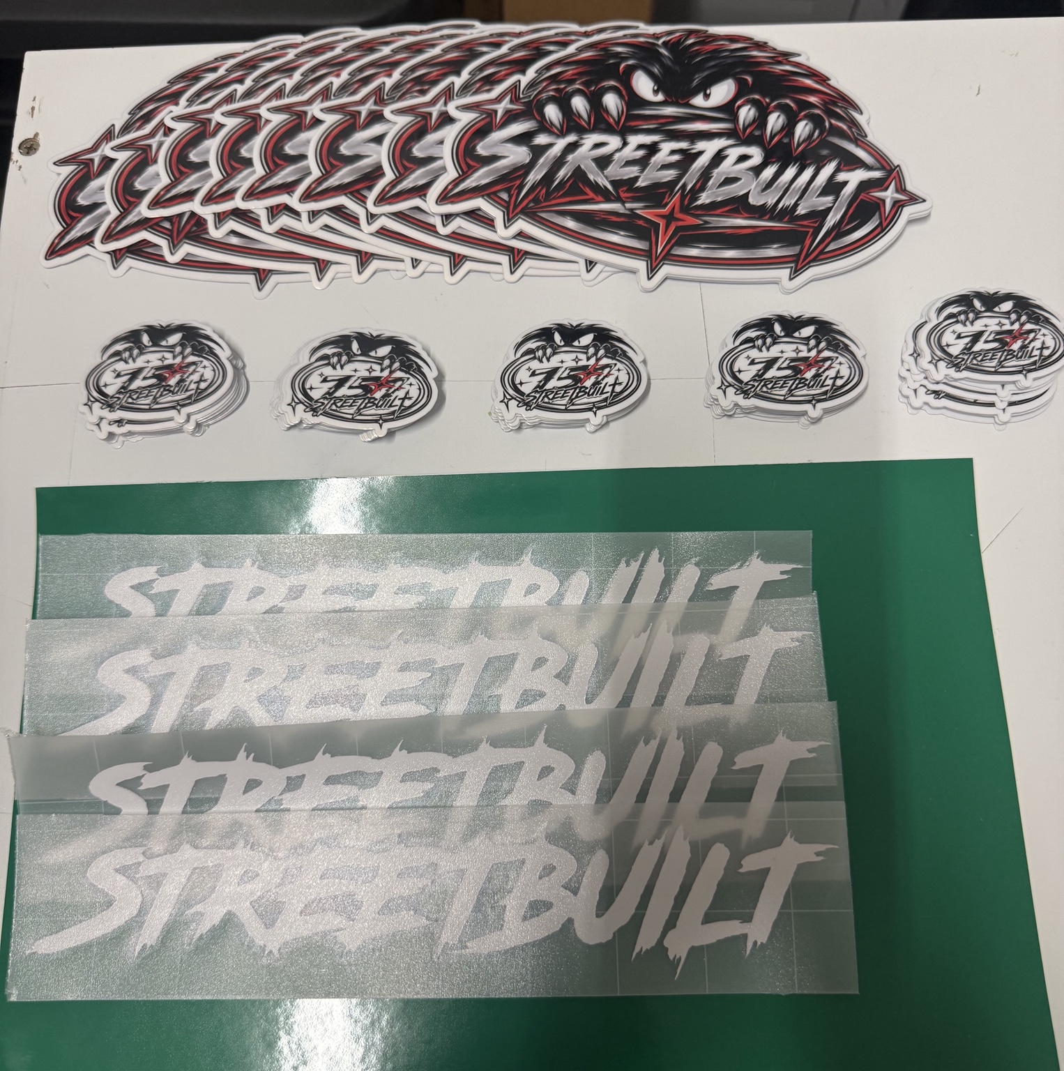 StreetBuilt printed stickers in multiple sizes alongside white cut vinyl lettering